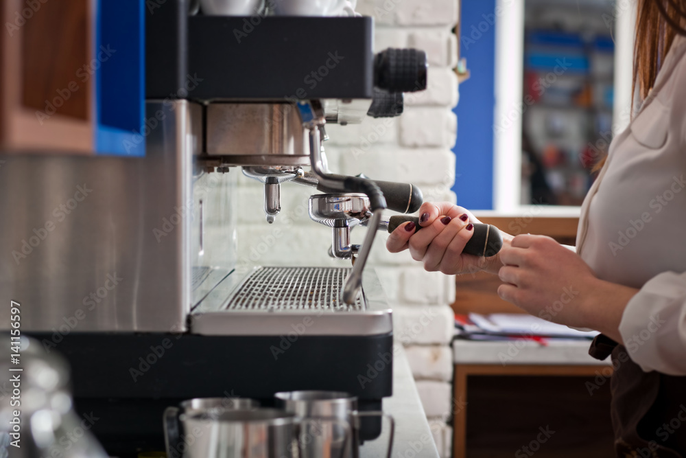 barista is preparing coffee on coffee machine