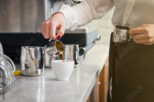 barista is preparing coffee on coffee machine