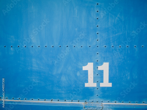 Number eleven in white with blue background and rivets, beautiful background with 11 photo