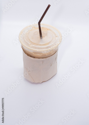 Iced coffee with straw in plastic cup on white background