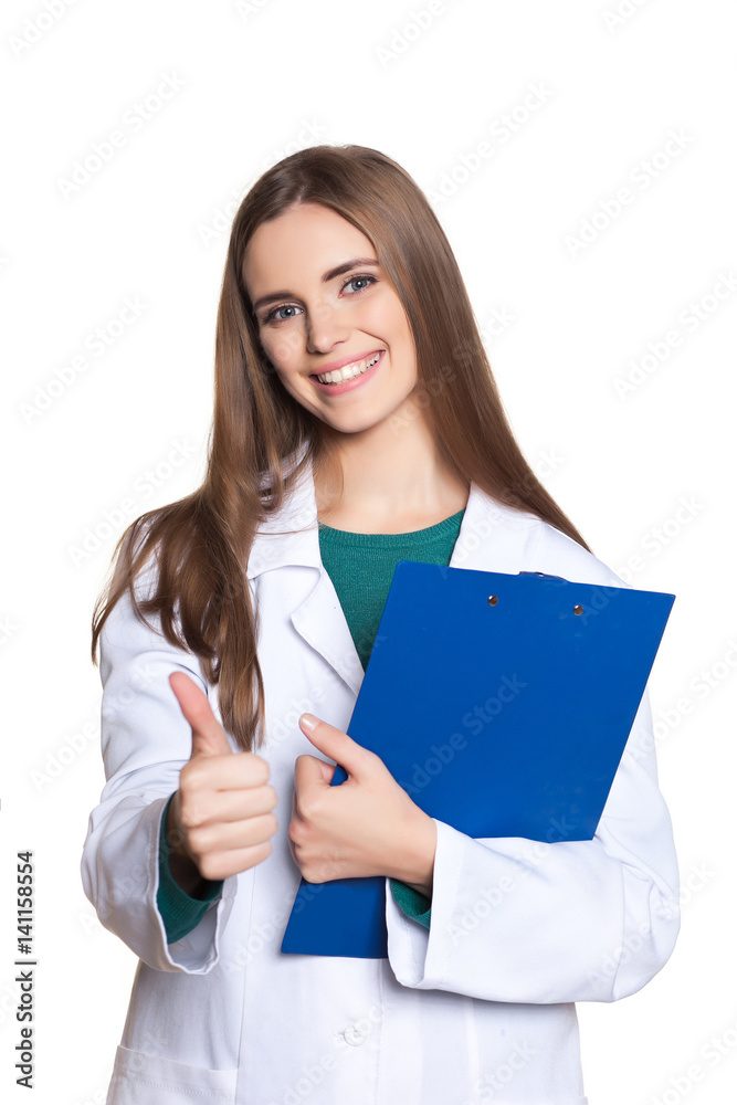 Young female student doctor with a tablet on a white background showing thumb Young female student doctor with a tablet on a white background showing thumb