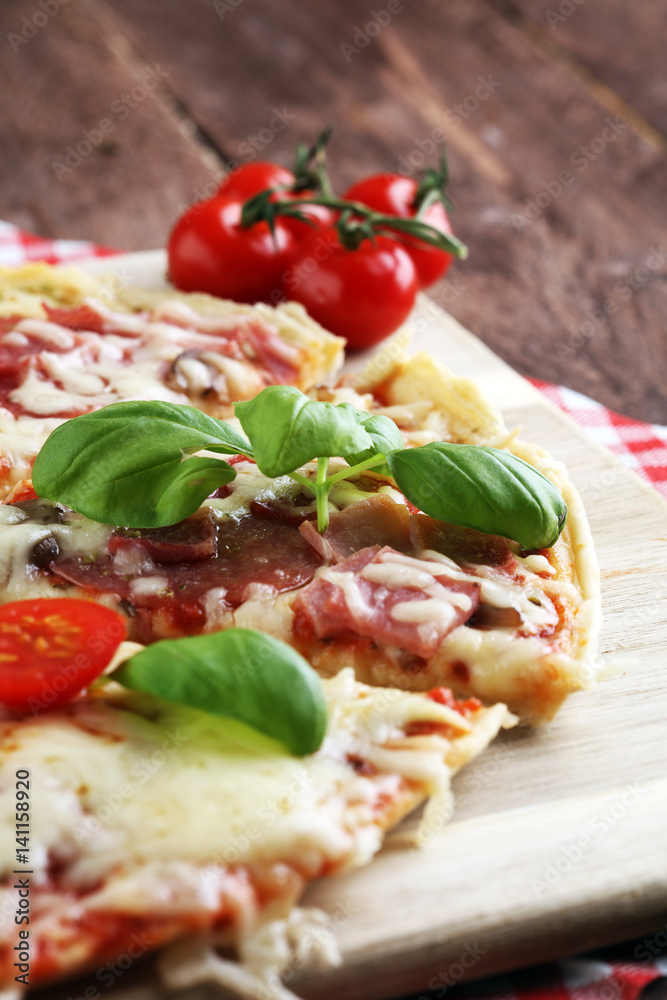 Hot true PEPPERONI ITALIAN PIZZA with salami and cheese. TOP VIEW Tasty traditional pepperoni pizza on board on wooden table with decoration Hot true PEPPERONI ITALIAN PIZZA with salami and cheese. TOP VIEW Tasty traditional pepperoni pizza on board on wooden table with decoration