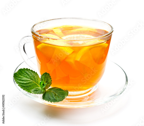 Isolated transparent cup of herbal tea with lemon and mint