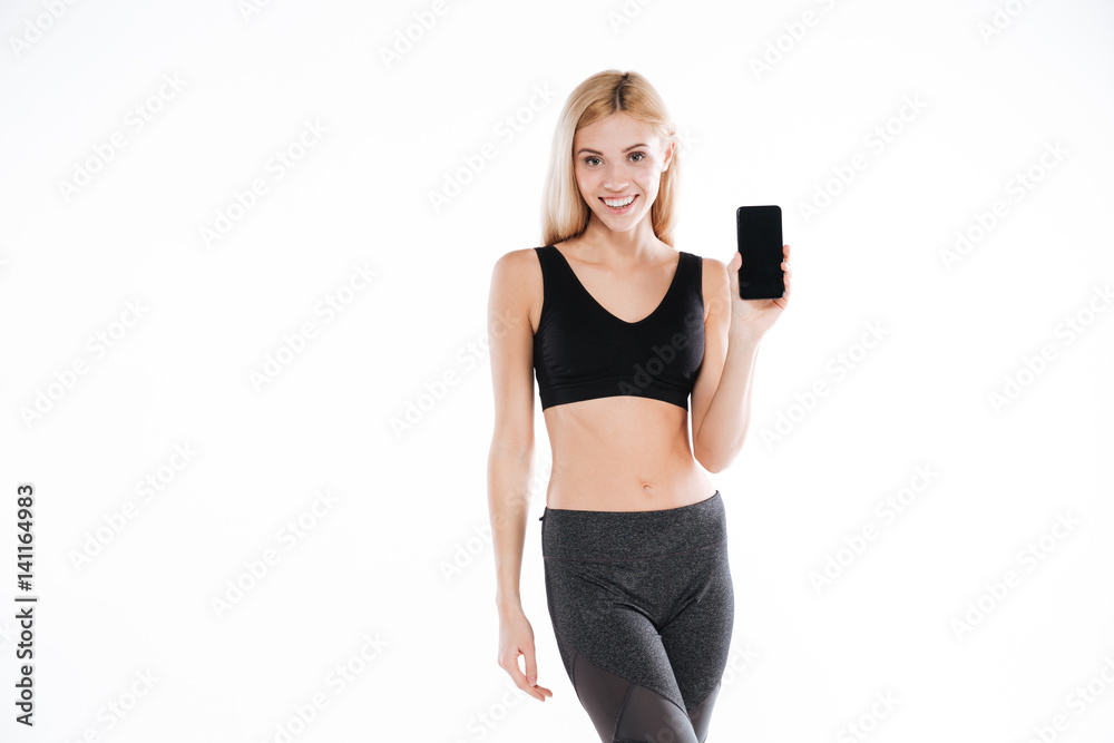 Fitness lady showing mobile phone display. Fitness lady showing mobile phone display.