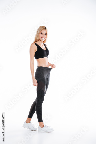 Pretty fitness woman standing and posing isolated