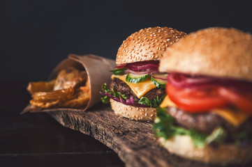 two mouth-watering, delicious homemade burger used to chop beef. on the wooden table.