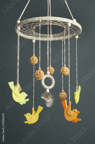 Baby crib mobile on gray background