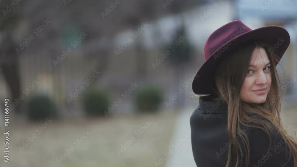 Beautiful young girl with an attractive appearance, adorable look, long hair, autumn coat in the city. Steadicam, slow mo shot Beautiful young girl with an attractive appearance, adorable look, long hair, autumn coat in the city. Steadicam, slow mo shot