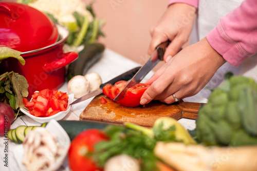 Vegetable cutting, woman cut tomato with a knife