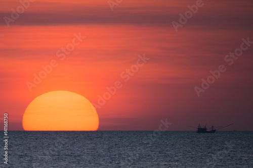 Big sun and a fisherman boat at sunset in Phuket - Thailand © Travel Wild