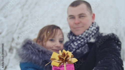 Young couple in a park with present . The concept of love and relationships. photo