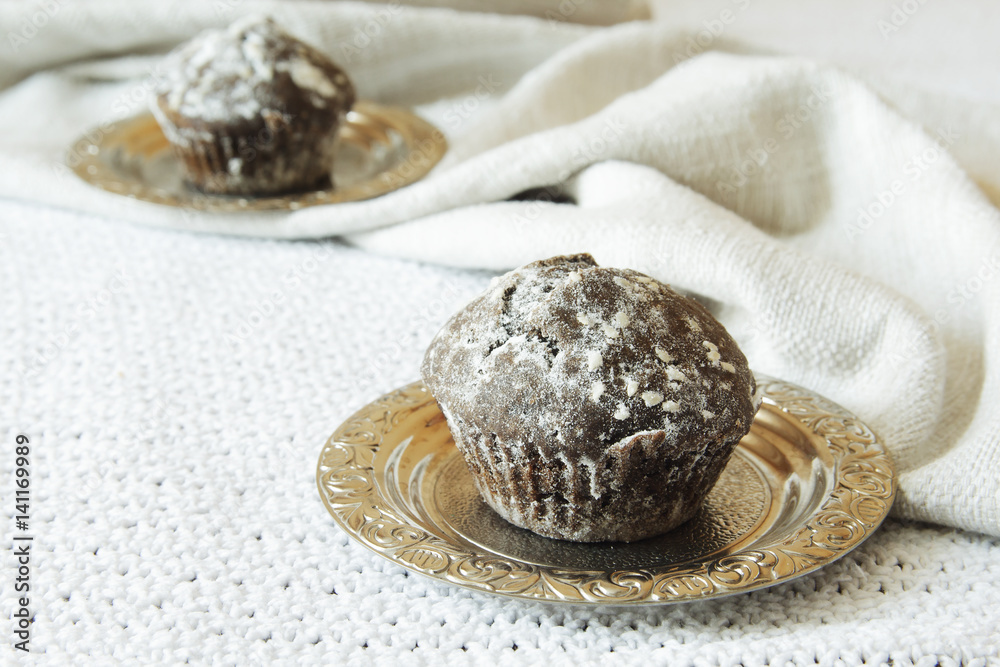 Homemade Chocolate Cupcake on plate against a background Homemade Chocolate Cupcake on plate against a background