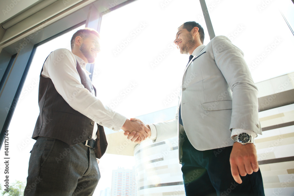 Business people shaking hands, finishing up a meeting.