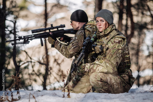 Photo team of special forces weapons in cold forest