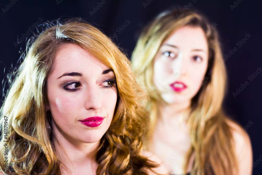 Two beautiful women Portrait over Black Background Two beautiful women Portrait over Black Background