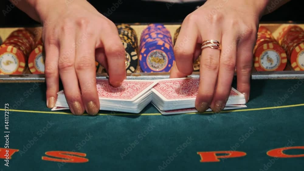 Casino: Dealer shuffles the poker cards. Casino: Dealer shuffles the poker cards.