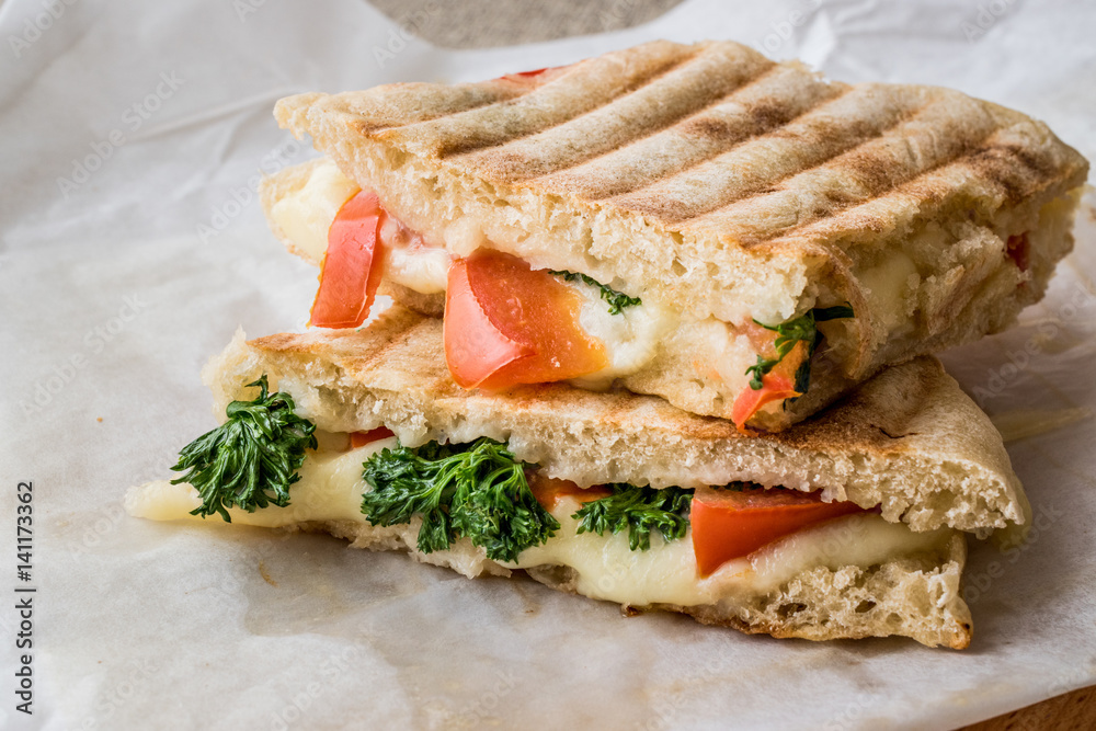 Turkish Bazlama Tost / Toast sandwich with melted cheese, tomatoes and dill.