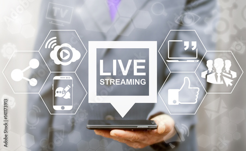 Live streaming social media web network concept. Man offers smart phone with bubble live streaming icon on virtual screen. Broadcast online technology stream video and music. Internet marketing.