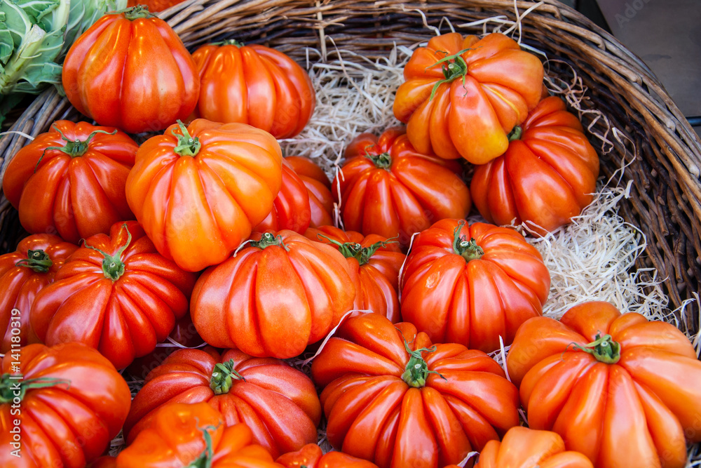 Shiny ripe beefsteak tomatoes at farmers market in Paris (France)