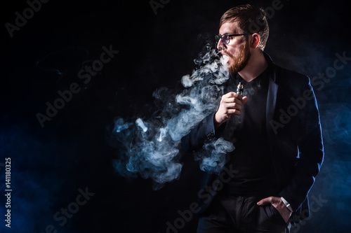 The man releases smoke. E-c...