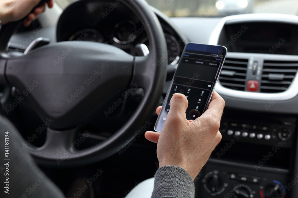 Risky danger driving concept. Man using mobile phone while driving a car