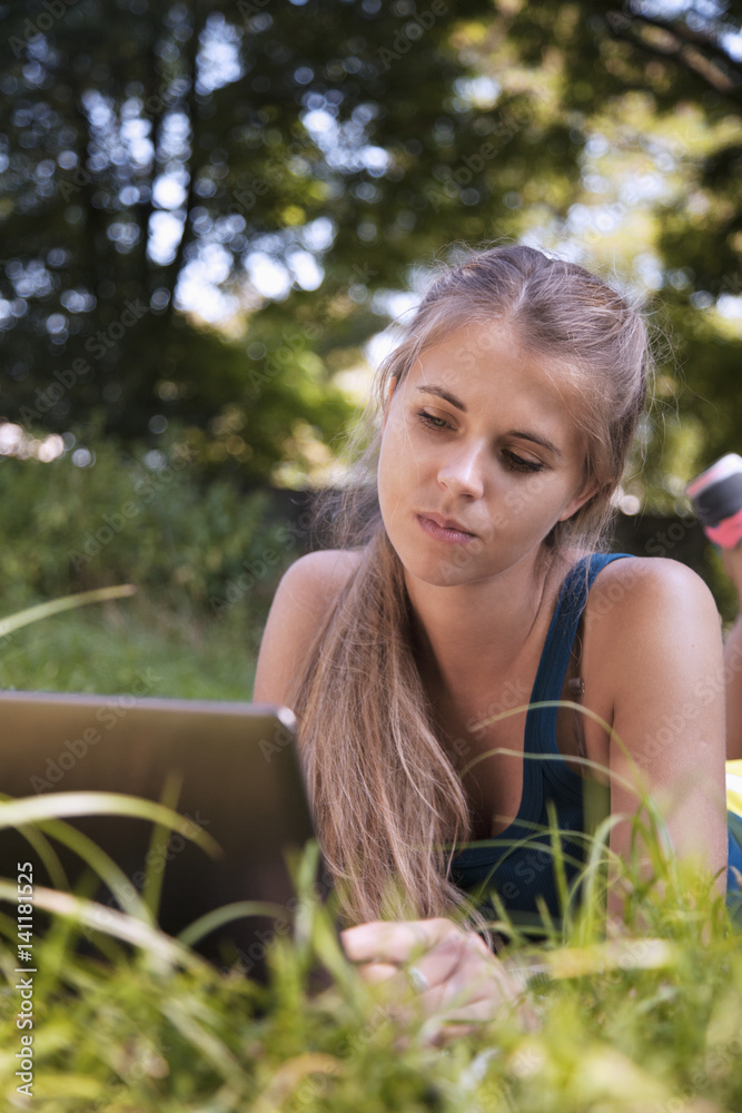 beautiful woman working working with a laptop in a green park. (freelance, time management, success, freedom) beautiful woman working working with a laptop in a green park. (freelance, time management, success, freedom)