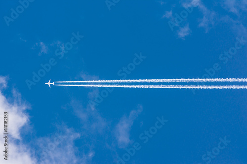 White Clouds Blue Sky Fluffy Sun Flare Airplane Trail  Sunny Daytime Texture Background