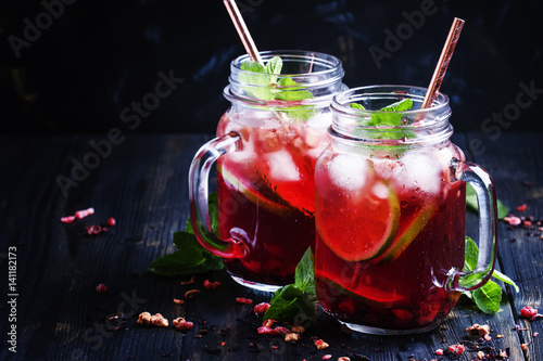 Tea with hibiscus, fruit, mint and ice, selective focus