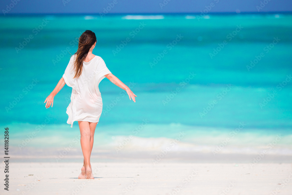 Young beautiful girl on tropical beach at caribbean vacation Young beautiful girl on tropical beach at caribbean vacation