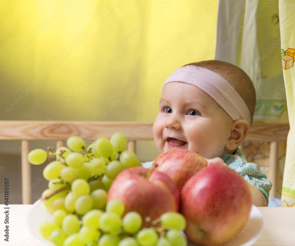 dear small emotional child near a fresh fruits dear small emotional child near a fresh fruits