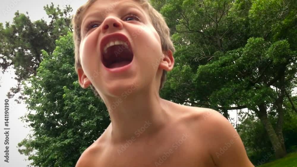 Young boy yelling from the top of his lungs during holiday vacations / ultra slow motion clip in 120 fps