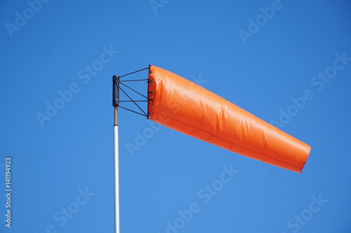 close up on orange windsock in the wind photo