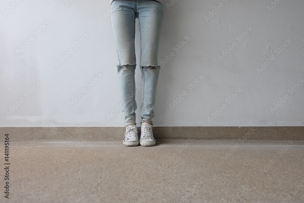 Fototapeta Feet From Above Concept, Teenage Person in White Sneakers Standing on Ground Background Great for Any Use.