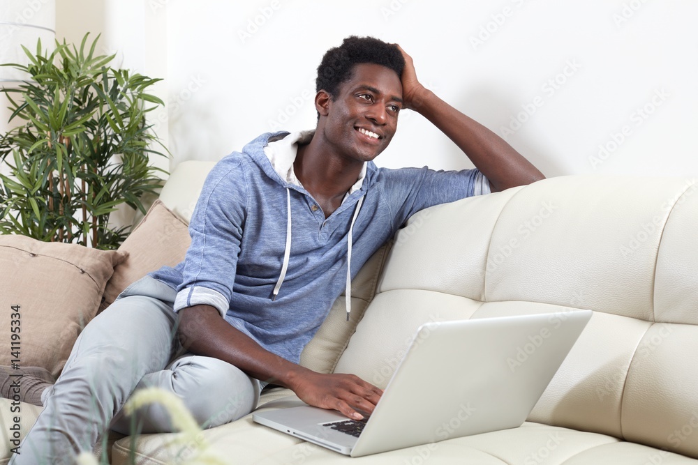 African-American man with laptop.