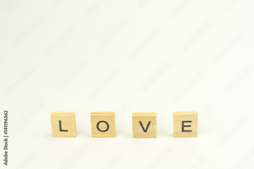 Text wooden blocks spelling the word LOVE on white background Text wooden blocks spelling the word LOVE on white background