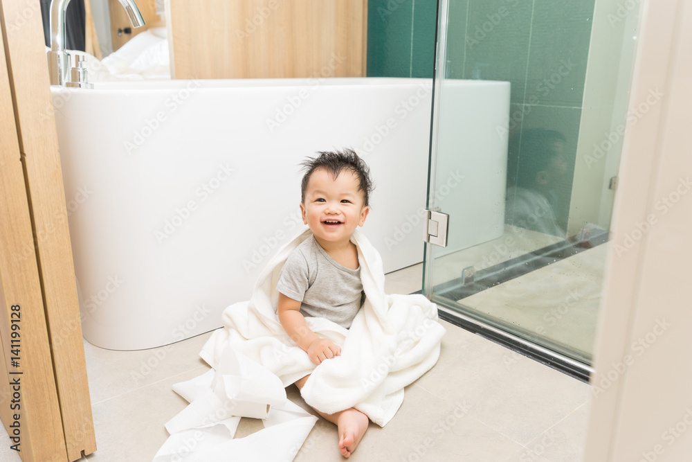 Asian kid in the bathroom with bathtub Asian kid in the bathroom with bathtub