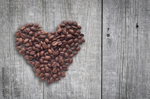 Coffee beans in form of heart on beautifull background. Love. Insparation. On wooden background.