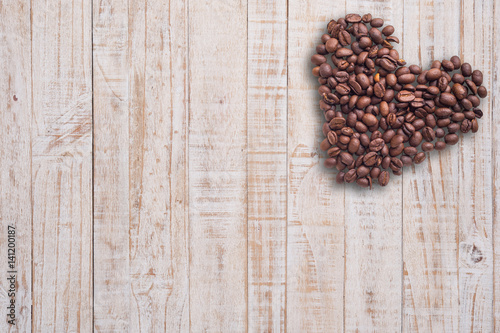 Coffee beans in form of heart on beautifull background. Love. Insparation. On wooden background.