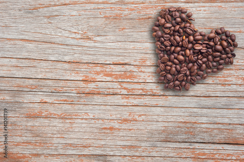 Coffee beans in form of heart on beautifull background. Love. Insparation. On wooden background.