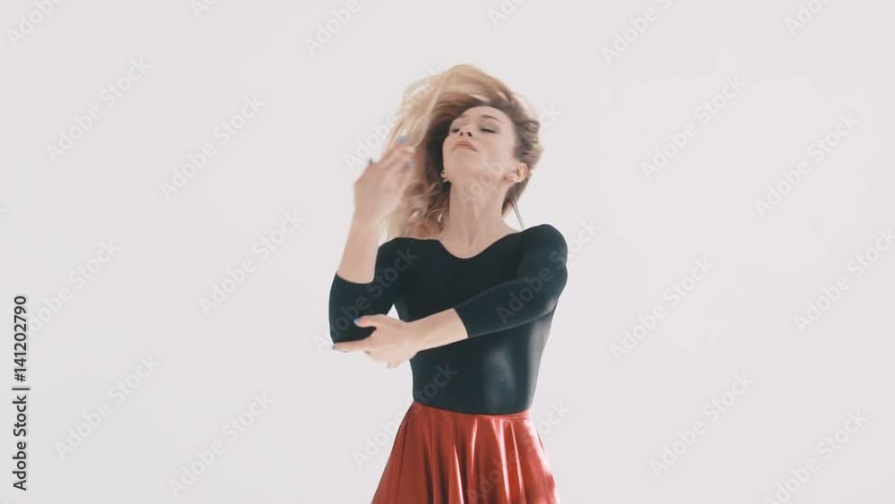 Young beautiful ballerina dancing on white background. Red skirt fluttering. The Ballerina Project. Young beautiful ballerina dancing on white background. Red skirt fluttering. The Ballerina Project.