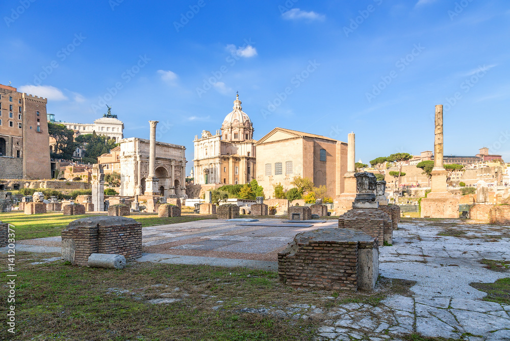 Obraz premium Rome, Italy. Ruins of the Roman Forum: Tabularia, Julia Basilica, the arch of Septimius Severus, the column of Phocas, Curia Julia, the Columns of Honor