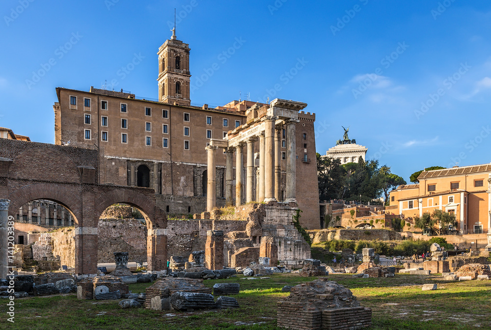 Rome, Italy. Ruins of the Roman Forum: the temple of Saturn (489 BC - 283 AD) against the background of Tabularia