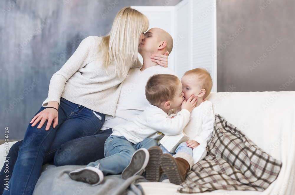 The kissing parents and children. Family happiness and love. Happy parents and children.