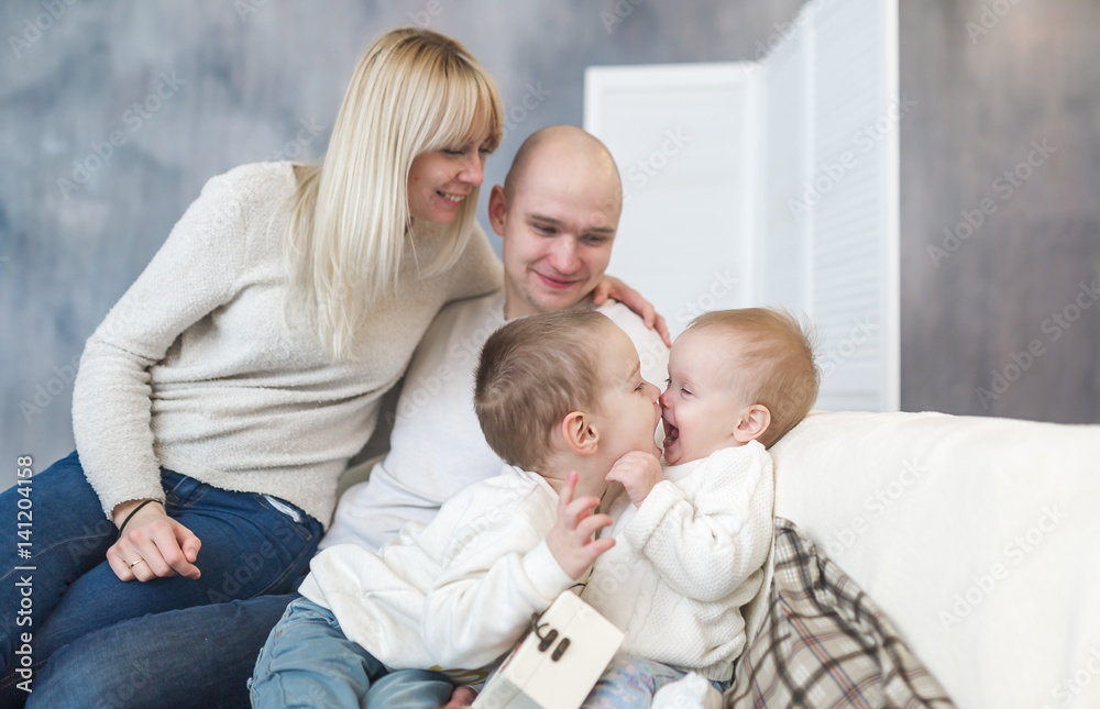 The kissing parents and children. Family happiness and love. Happy parents and children.