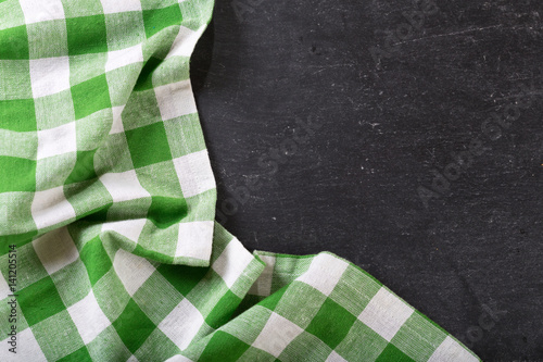green checkered tablecloth on dark table