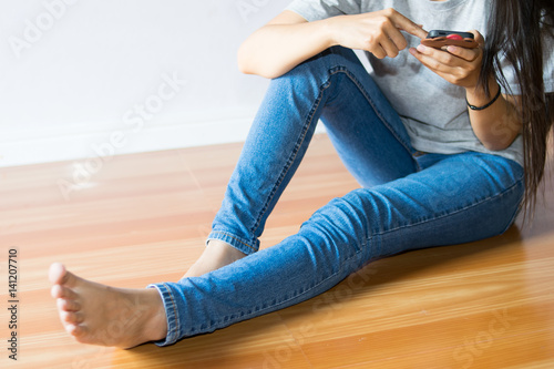 girl sitting and using smartphone