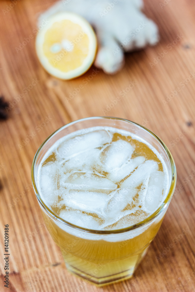 Alcohol free home ginger beer on glass on wooden surface Alcohol free home ginger beer on glass on wooden surface