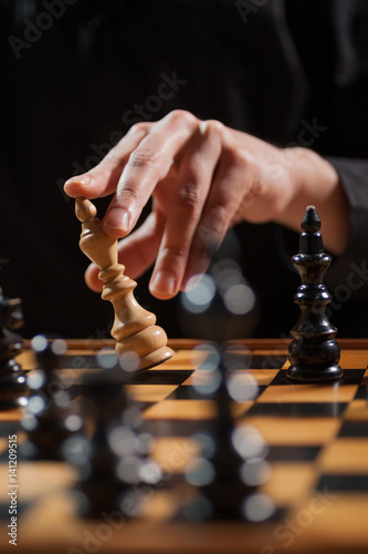 Close up image of man who is capitulating in chess game.