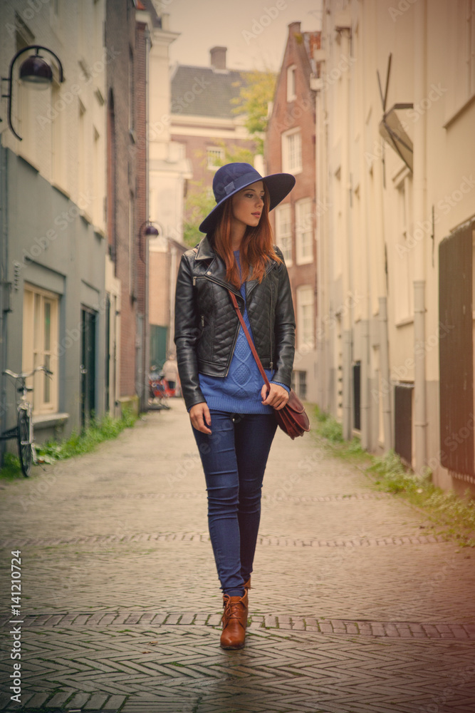 beautiful young woman walking on the street and exploring the town