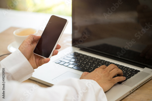 Businessman's hands with Mobile phone.\ photo